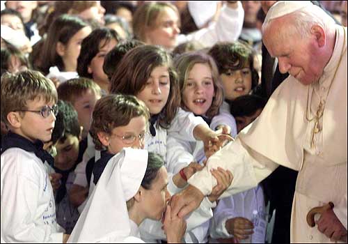 Pope John Paul II was kissed by a nun as he arrived at the Chapel of Apparition in Fatima, Portugal.