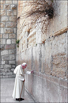 Pope John Paul II touched the Wailing Wall, the holiest site in Judaism, in Jerusalem. The pope was on a politically charged tour of three sites holy to Muslims, Jews, and Christians in the Holy Land.