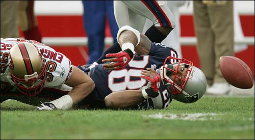 Patriots running back Corey Dillon fumbles the ball during the first quarter. It was the first of three turnovers on the day for New England.