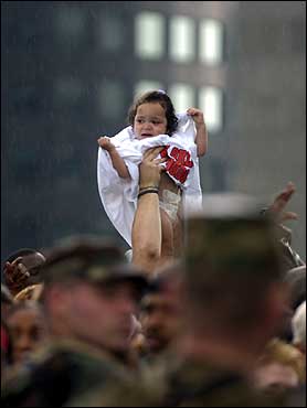 A Hurricane Katrina refugee held a baby up for air while the National Guard worked to control a massive crowd gathered outside the Louisiana Superdome in New Orleans Thursday.