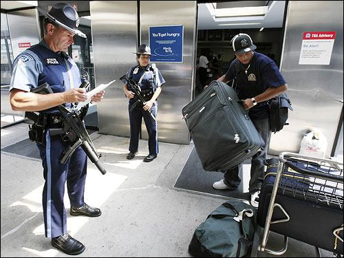 Massachusetts State Police stood on guard with automatic weapons at Logan today.