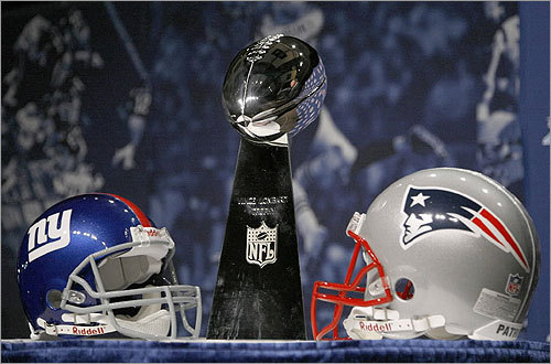 At Friday's press conference in Phoenix, the Vince Lombardi Trophy sat on display between the New York Giants and New England Patriots helmets.