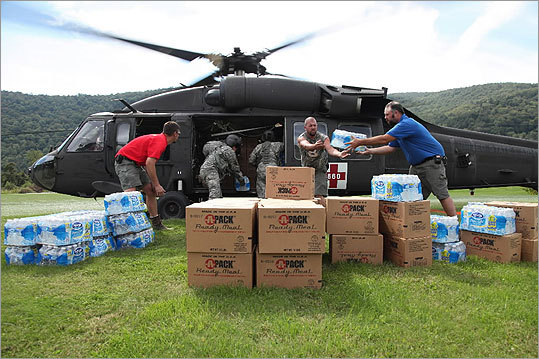 The Vermont National Guard airlifted emergency supplies to the isolated town of Rochester, where civilians helped unload the cargo.