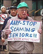 An angry senior citizen criticizes AARP's endorsement of the Medicare bill outside the group's Boston office.