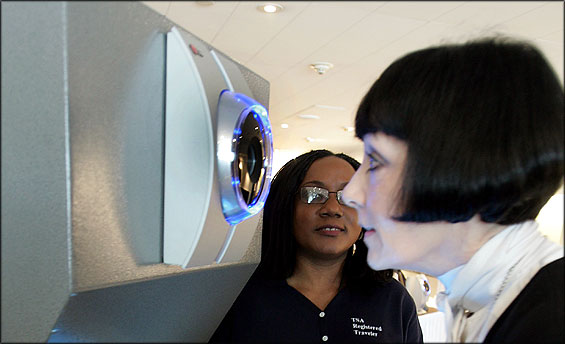 Marybeth Pompei of Cambridge had her iris checked at Logan Airport yesterday as TSA contractor Ola Martins observed.