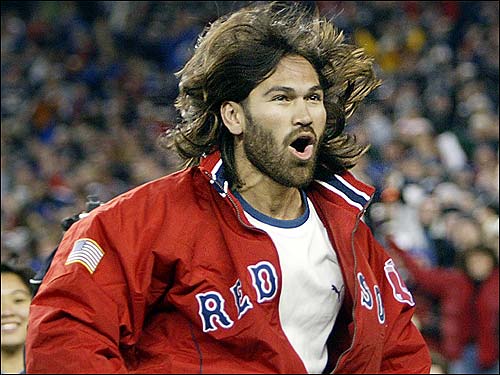 After twice being honored by the Red Sox at Fenway Park, the Patriots returned the favor last night and welcomed the World Series champions to Gillette Stadium. Johnny Damon has his hair flying as he bounces up and down while being introduced before the game.