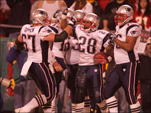 Cory Dillon (28) celebrates in the end zone after scoring on a 5-yard run on the Patriots’ first series of the game.