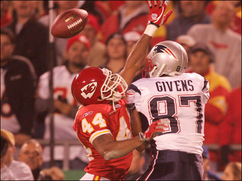 Chiefs cornerback Eric Warfield knocks away a pass intended for the Patriots’ David Givens.