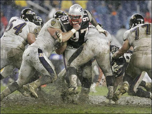 Torrential rain turned Gillette Stadium into a muddy mess Sunday. Patriots defensive lineman Jarvis Green makes his way through the muck and mire in the fourth quarter.