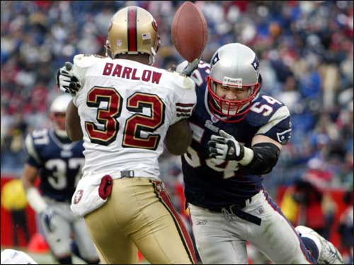 Patriots linebacker Tedy Bruschi (54) puts a hard hit on the 49ers running back Kevan Barlow, causing him to drop a pass for an incompletion.