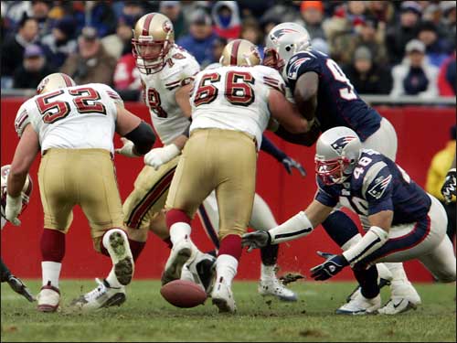 Patriots linebacker Tully Banta-Cain (48) falls on a third-quarter fumble by 49ers running back Maurice Hicks, stopping a drive that brought the 49ers into Patriots territory.