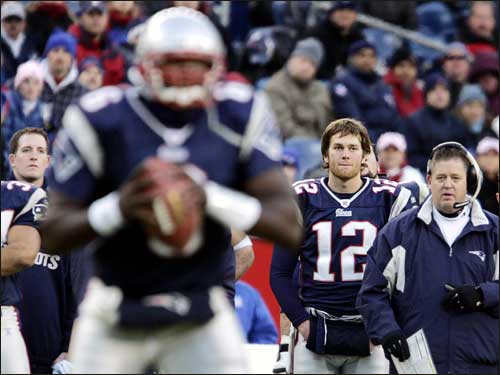 Patriots quarterback Tom Brady (12) spent the fourth quarter watching from the sidelines as backup QB Rohan Davey (foreground) ran the offense.