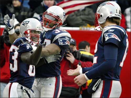 Patriots wide reciever Deion Branch (left) gets congratulations from fullback Patrick Pass (center) and quarterback Tom Brady (right) after his third-quarter touchdown reception put New England ahead 14-7.