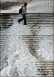 The steps at City Hall Plaza were only partly cleared yesterday.