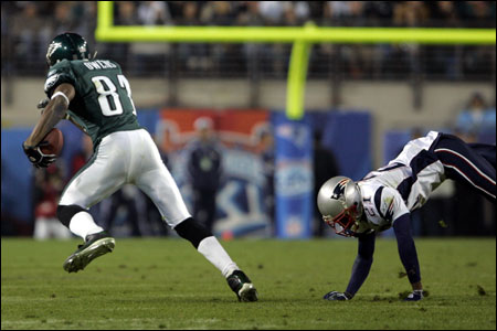 Terrell Owens turned in a healthy performance (9 receptions, 122 yards), as Randall Gay (right) could attest.
