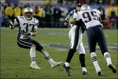 Safety Rodney Harrison welcomes the Super Bowl-clinching interception, his second pick of the game, with open arms in the final minute.