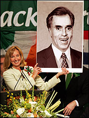 Lieutenant Governor Kerry Healey held a photograph of former House speaker Thomas M. Finneran with Governor Mitt Romney’s hair.