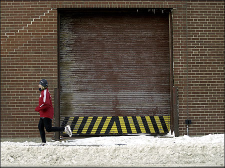 Michelle Zapponi pounds down a snowy South Boston street. (Globe Staff Photo / David Kamerman) More Marathon training photos