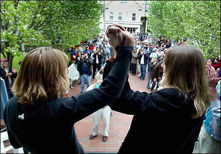 Truro residents Eileen Counihan (L) and Erin Golden acknowledged well-wishers outside Provincetown Town Hall after obtaining their marriage license in May 2004.