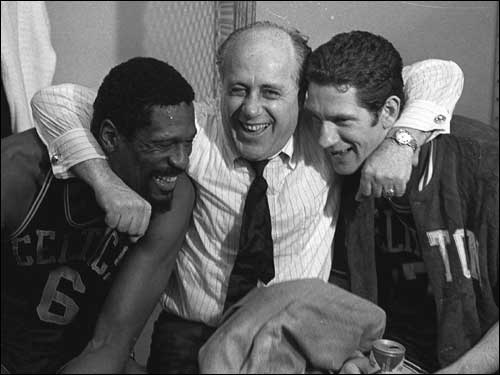 General manager Red Auerbach hugged player-coach Bill Russell (left) and John Havlicek (right), the stars of the Celtics win over the Lakers in the 1968 NBA Finals.