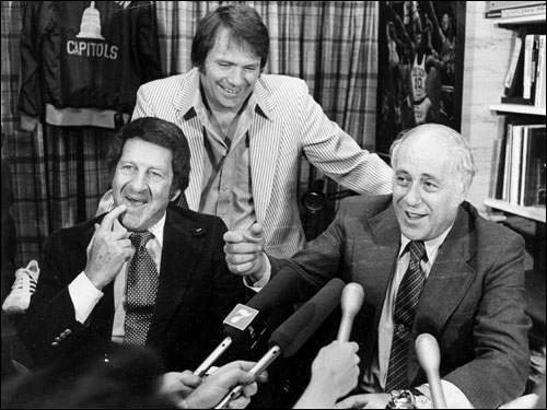 At a press conference in 1977, Auerbach and team owner Irv Levine (left) announced a multi-year contract extension for Celtics coach Tom Heinsohn (center). Heinsohn coached the Celtics' 1974 and 1976 championship teams, but stepped down in 1978 during the lean years of rebuilding.