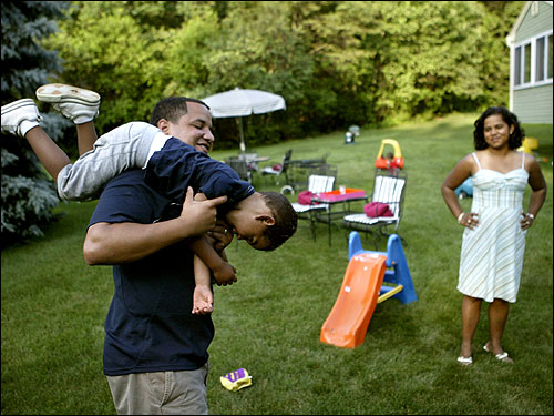 In predominantly white Andover, Shaun Morgan (left, with 3-year-old son Shaun Jacob) and his wife, Lily Mendez-Morgan (right) have different approaches to forging community.