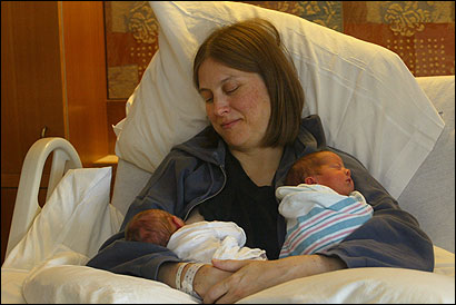 Deborah Savage, 43, recently snuggled with her twins, Leah Rose Woolf (left) and Mariana Grace Woolf.