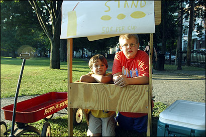 Dominic Serino (left), 9, and Ryan Decker, 11, were forced to pack up their lemonade stand at Salem Common on Saturday.