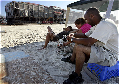 Johnny Hutcherson, Kelly Grishom, and Paul Washington sat on the beach in Biloxi, Miss., near the Grand Casino Biloxi.