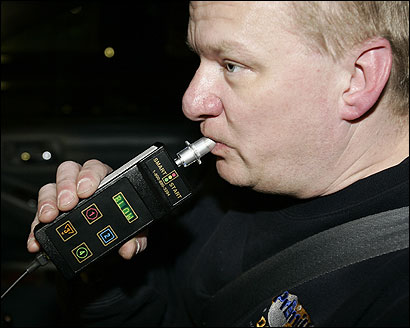 Chris Moberg, a technician at Premium Auto Detailing in Norwood, demonstrated how drivers are supposed to blow into the ignition interlock device, which will be unveiled today.