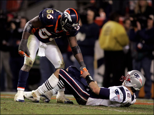 Linebacker Al Wilson helped quarterback Tom Brady up as Brady lay on his back during the fourth quarter.