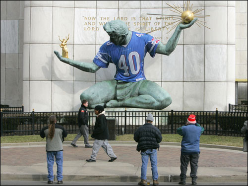 Tourists snapped photos of the Spirit of Detroit monument in downtown Detroit. The statue, an icon of the city, was adorned with a Super Bowl XL jersey.