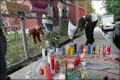 Friends of Analicia Perry arranged candles and wax in the shape of an A in honor of their friend, who was gunned down on Albert Street late Saturday evening.