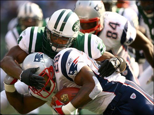 Jets linebacker Victor Hobson tackled Patriots running back Corey Dillon.