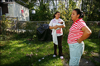 Mireya Jimenez and her daughter, Yomary Kelly, were in their Roslindale backyard near the place where baby Jordan was discovered. Kelly was holding her 3-week-old son, Nomar.