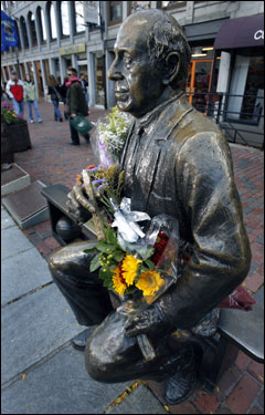 Flowers covered the statue of the late Arnold 'Red' Auerbach in Faneuil Hall.
