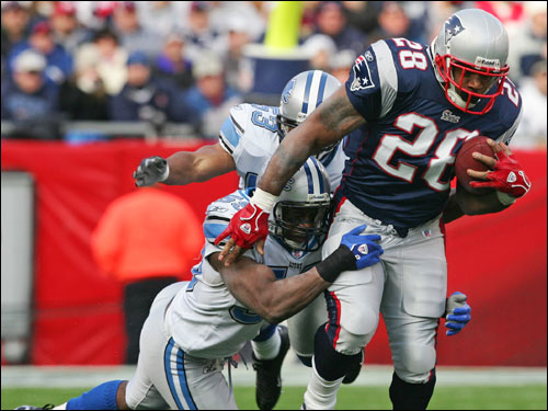 Corey Dillon was tackled by Detroit Lions linebackedr Donte Curry on a rush in the second quarter.
