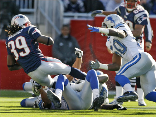 Patriots running back Laurence Maroney (39) was brought down by the Lions' Terrence Holt and Ernie Sims on a third-down carry in the first period. He picked up three yards on the carry for the first down, but did not carry the ball again in the game.