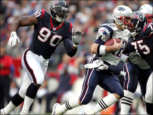 Texans defensive lineman Mario Williams chased Tom Brady as he tucked and ran in the first half.