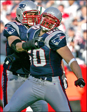 Patriots Mike Vrabel (right) and teammate Tedy Bruschi react after Vrabel almost intercepted the ball during the second quarter.