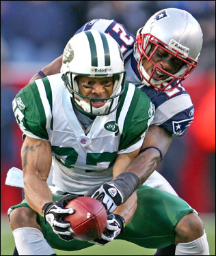 Jets receiver Laveranues Coles (left) made a catch for a 14-yard gain with defensive pressure from Patriots corner Ellis Hobbs.