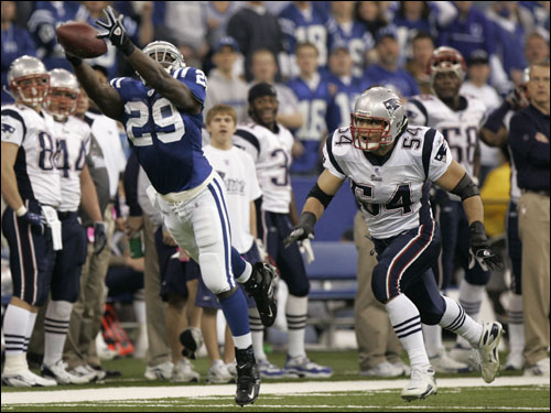 Colts running back Joseph Addai (29) leaped in front of Patriots linebacker Tedy Bruschi (54) but couldn't grab a long pass in the first quarter.