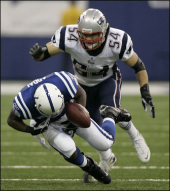 Joseph Addai (left) could not come up with the deep pass, which was defended by Tedy Bruschi.