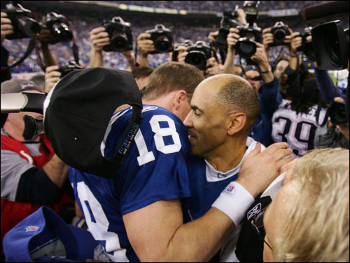 Peyton Manning (left) and Tony Dungy embraced after the Colts' victory over the Patriots.