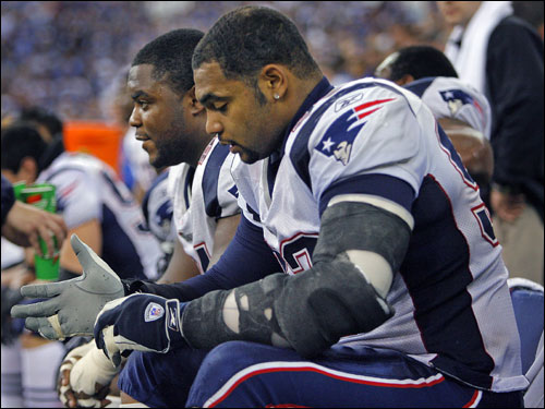 Richard Seymour (right) and Ty Warren are despondent on the bench together after the Colts scored late in the fourth quarter.