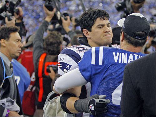 Former teammates Tedy Bruschi (left) and Adam Vinatieri (right) embraced after the game.