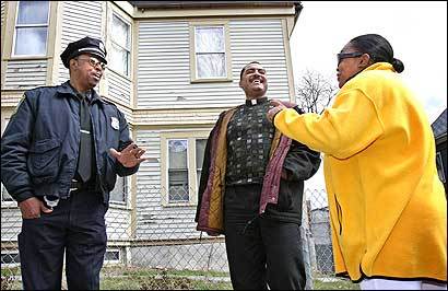 Boston police Officer James Gunn (left) and the Rev. Oscar Pratt (center) talked with a resident near the Grove Hall section of Roxbury yesterday about a new anticrime program.