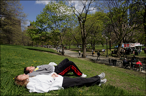 Ellen Leone and Dean Leone rest in the warm sun on the Boston Common after they finished the Walk for Hunger.