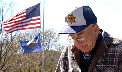 Bob Baumer, 85, of Sugar Hill, N.H., outside Town Hall in Franconia, where the flag flew at half-staff yesterday in honor of police Officer Bruce McKay.