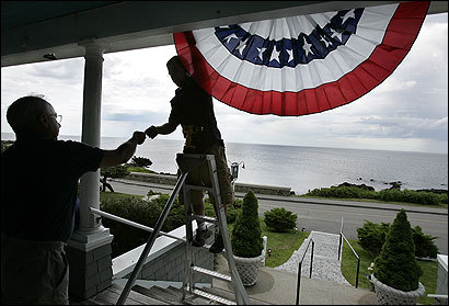 Nick Pelletier (on ladder) helped Kennebunkport, Maine, inn owner Jack Nahil hang a banner in anticipation of Russian President Putins arrival next Sunday.